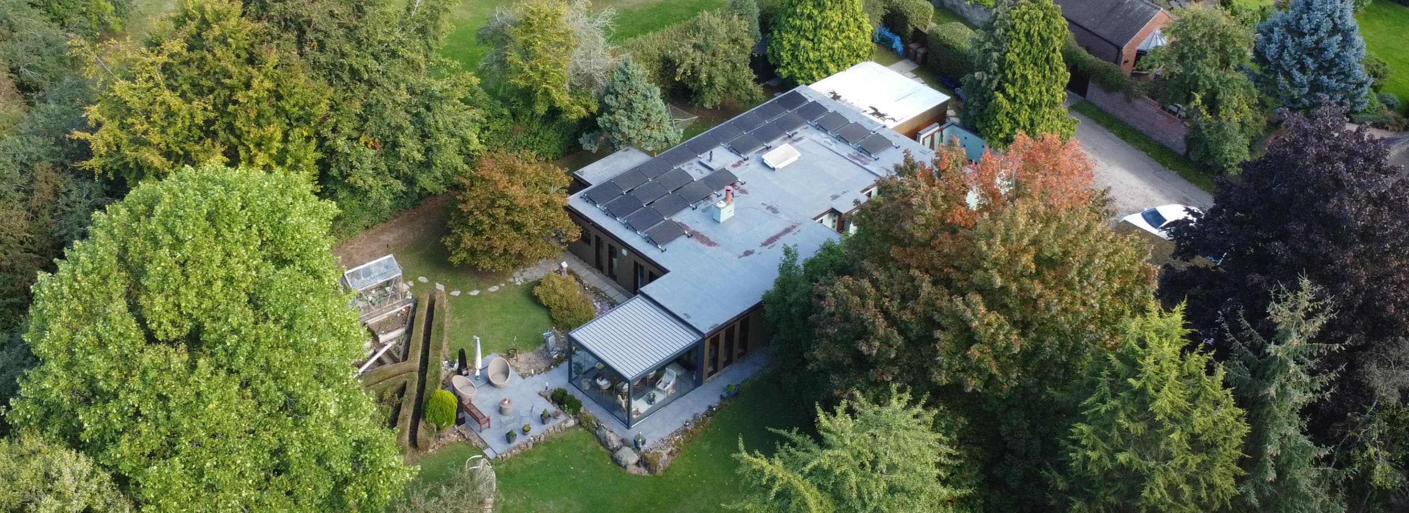 home with solar panels on flat roof