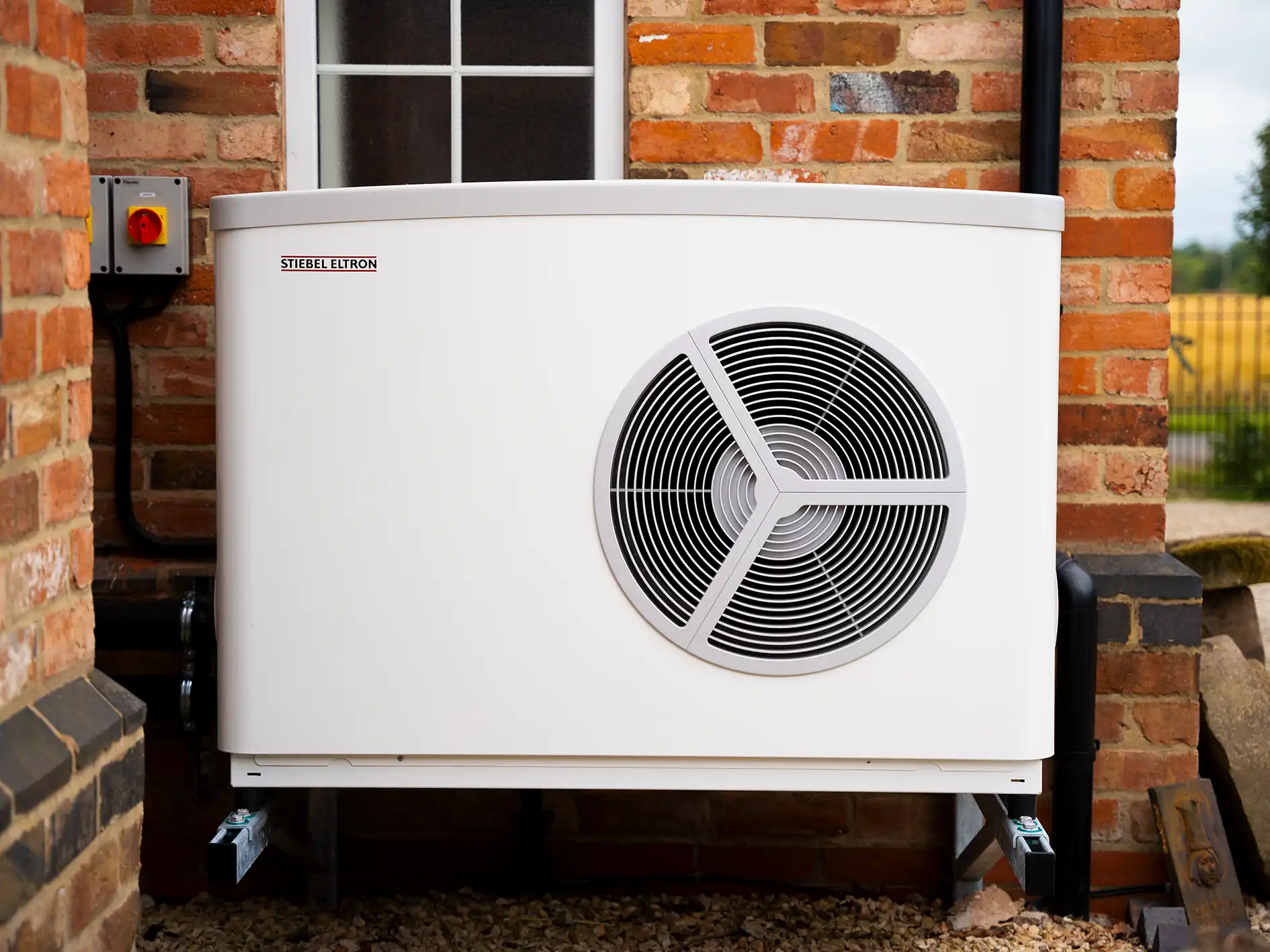 air source heat pump installed outside a house