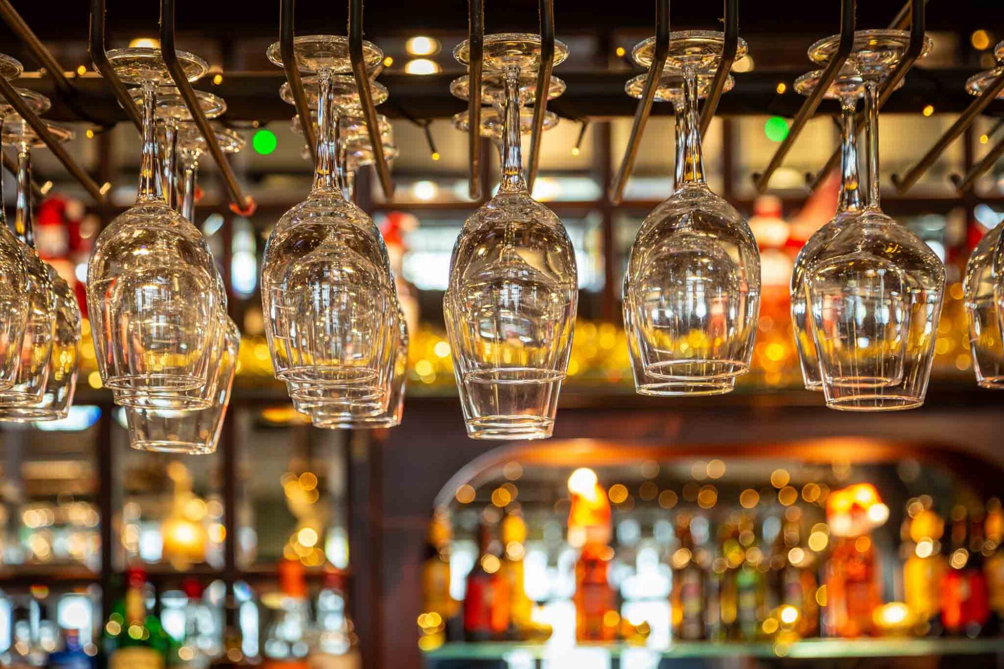 wine glasses hung up in pub